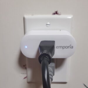 Emporia Smart Plug with a Black cord plugged into it